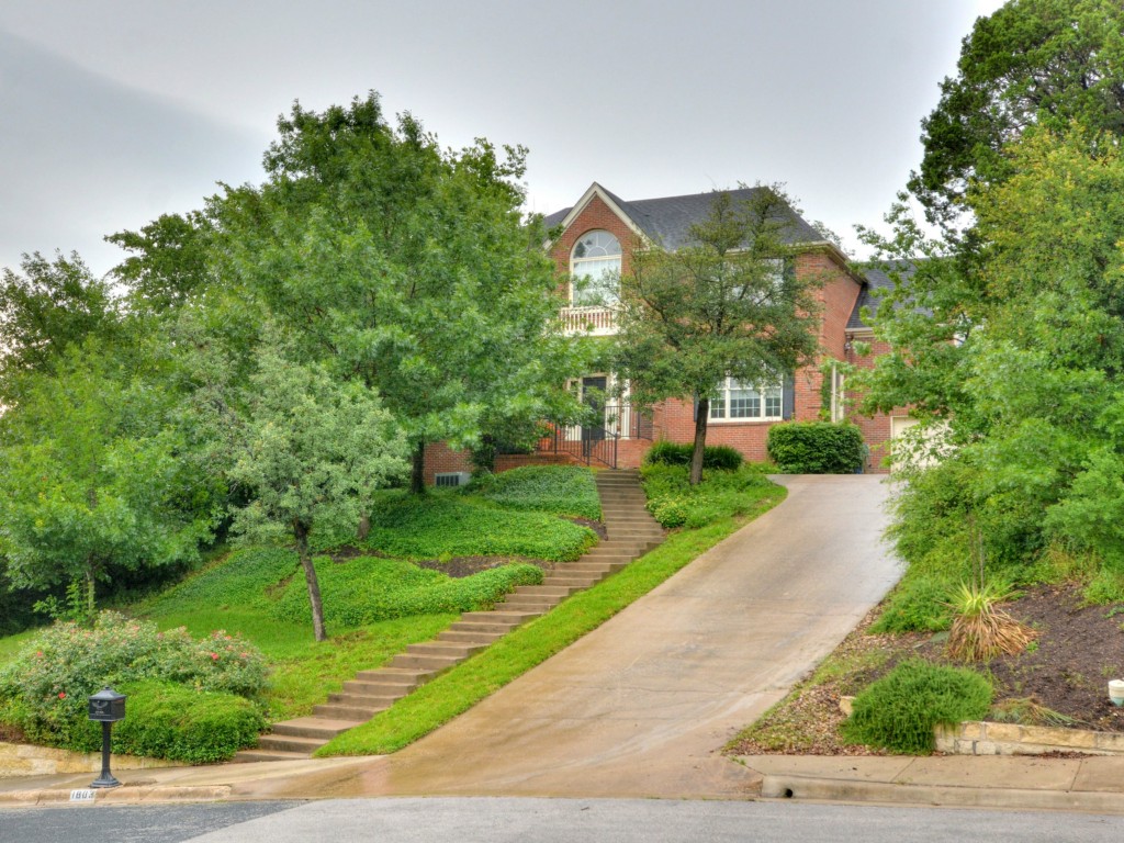 1803 Intervail Drive Austin, TX 78746 - Photo 1 of 1 a view of a street with a house in the background