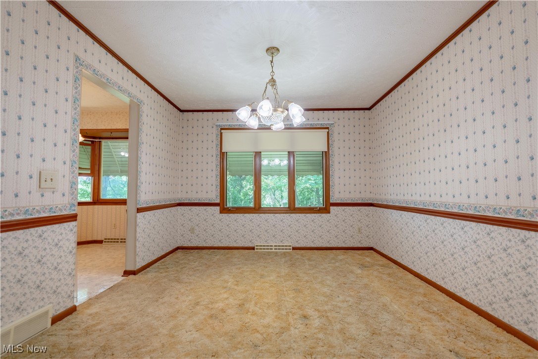 5535 Veldon Circle Northeast Canton, OH 44721 - Photo 6 of 41 Dining room with a chandelier and window to the rear.