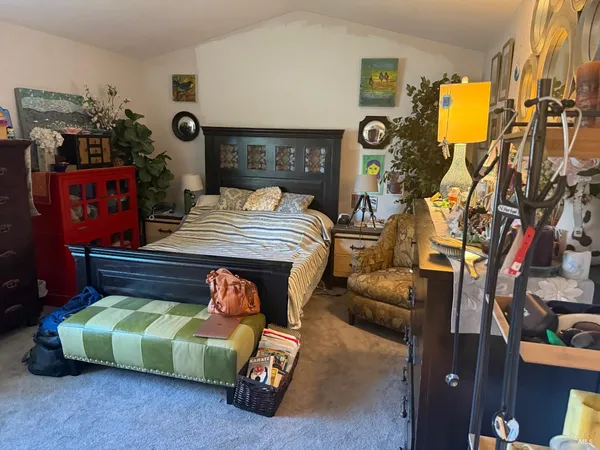 a bedroom with bed and gym equipment