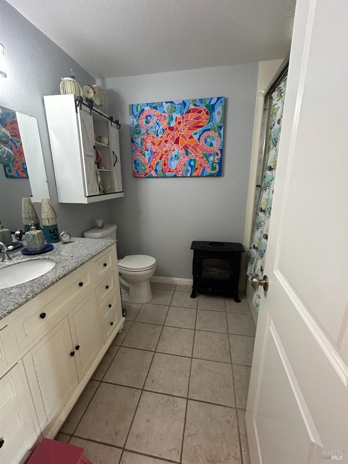 2813 Beth Court Santa Rosa, CA 95403 - Photo 19 of 24 a bathroom with a sink a toilet and a shower curtain