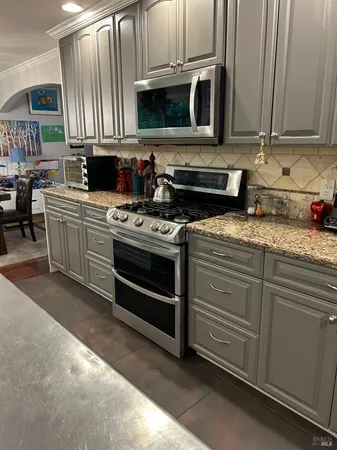 a kitchen with granite countertop a stove and a sink