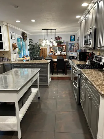 a kitchen with kitchen island granite countertop lots of counter top space