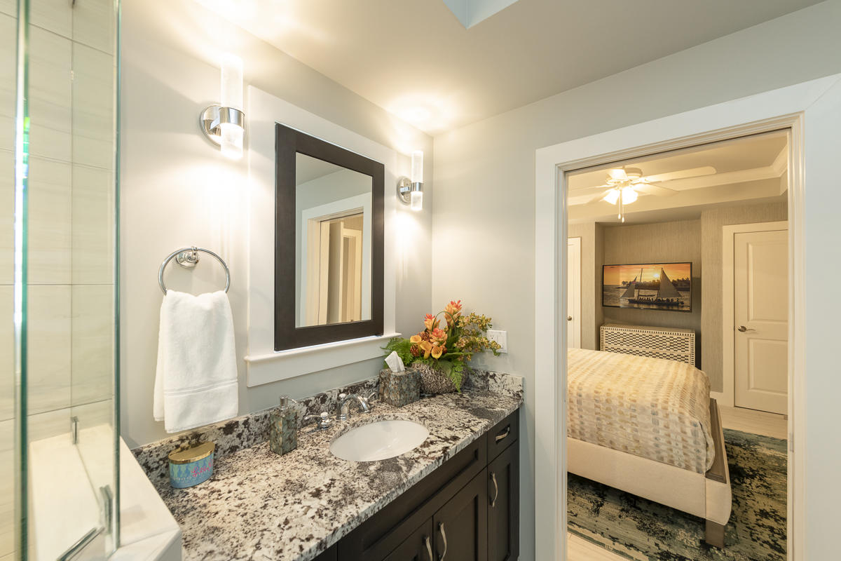139 Simonton Street Key West, FL 33040 - Photo 18 of 68 a en suite bathroom with a granite countertop sink and mirror