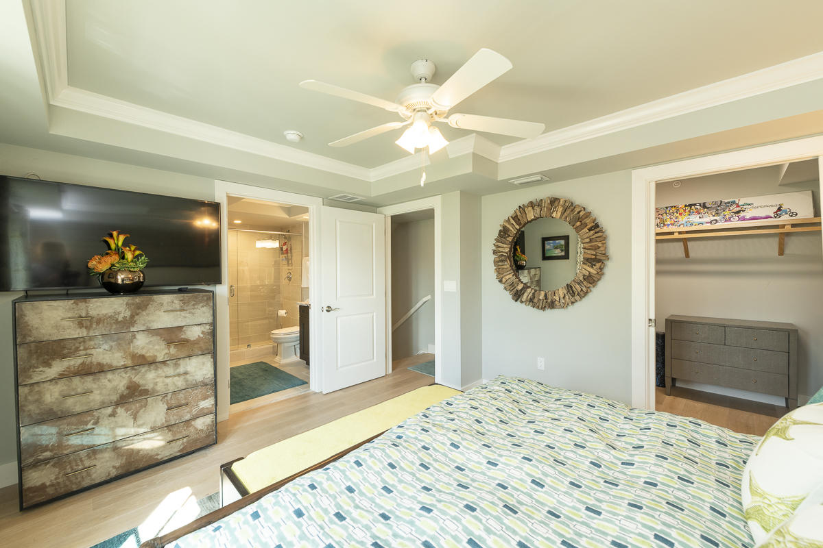 139 Simonton Street Key West, FL 33040 - Photo 23 of 68 a bedroom with a bed and a chandelier