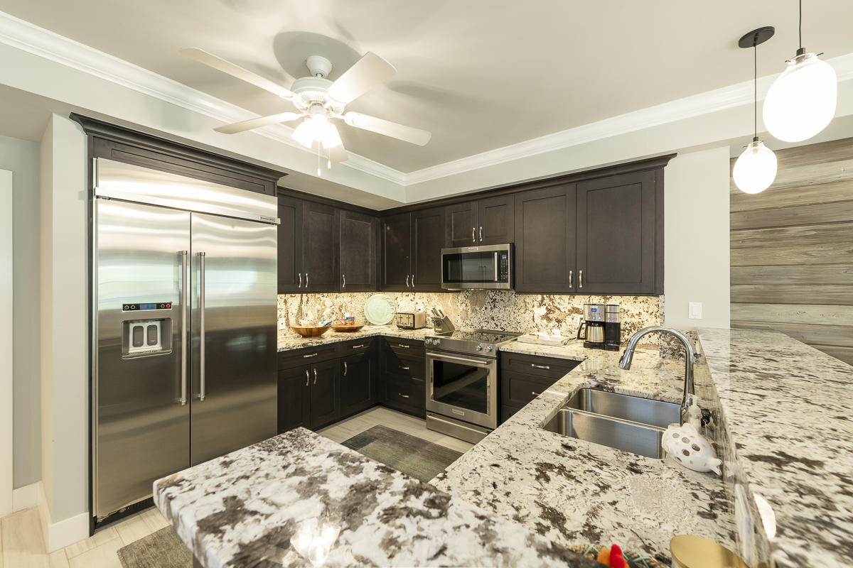 139 Simonton Street Key West, FL 33040 - Photo 4 of 68 a kitchen with a stove a sink and a refrigerator