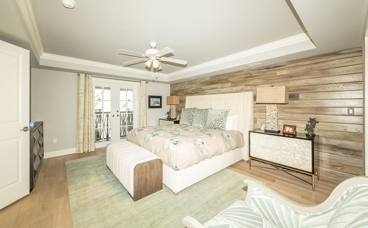 139 Simonton Street Key West, FL 33040 - Photo 32 of 68 a spacious bedroom with a large bed and a chandelier