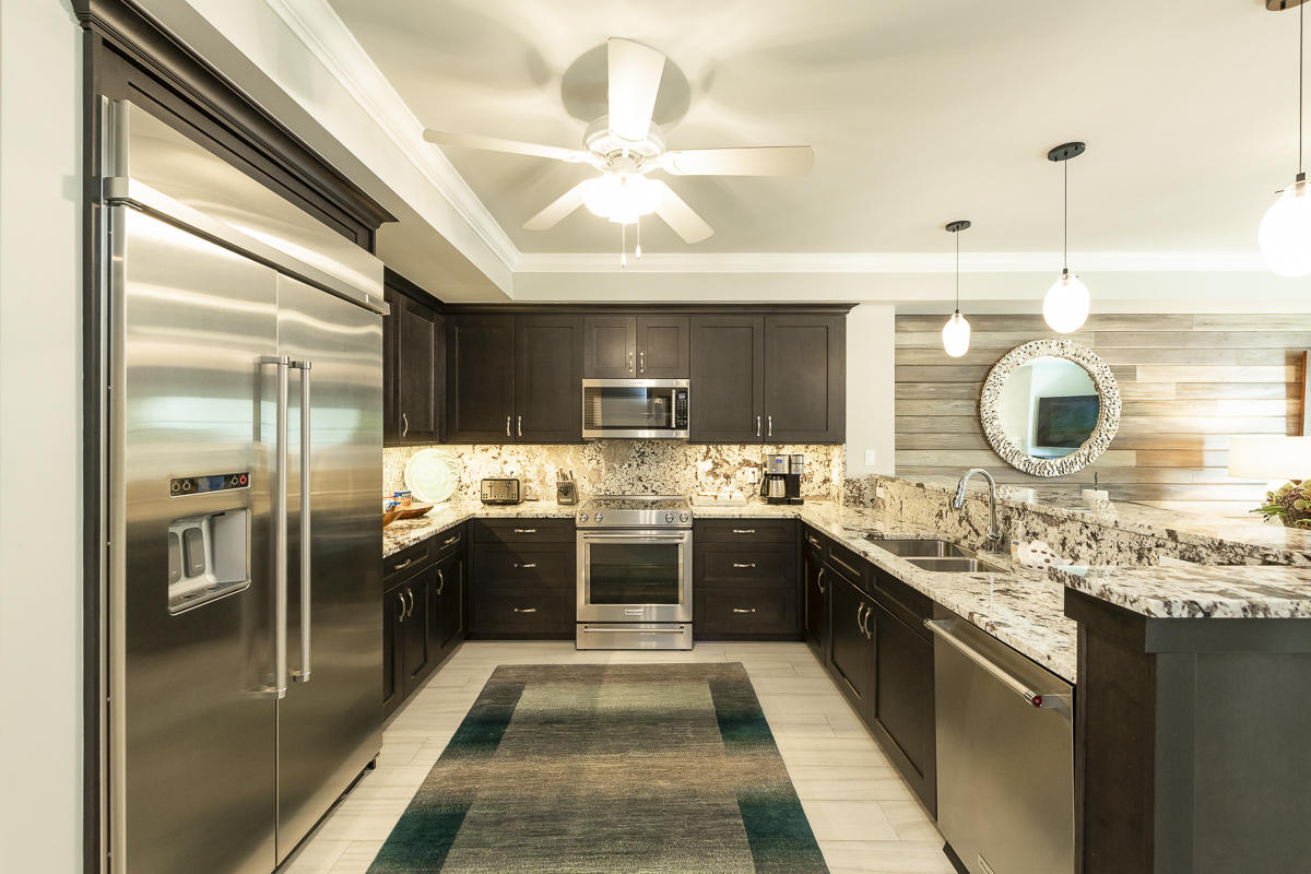139 Simonton Street Key West, FL 33040 - Photo 5 of 68 a large kitchen with stainless steel appliances kitchen island granite countertop a large kitchen island a stove a refrigerator a sink and dishwasher with a dining table