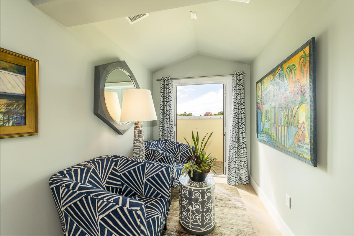 139 Simonton Street Key West, FL 33040 - Photo 41 of 68 a bedroom with a bed and a large mirror next to a window
