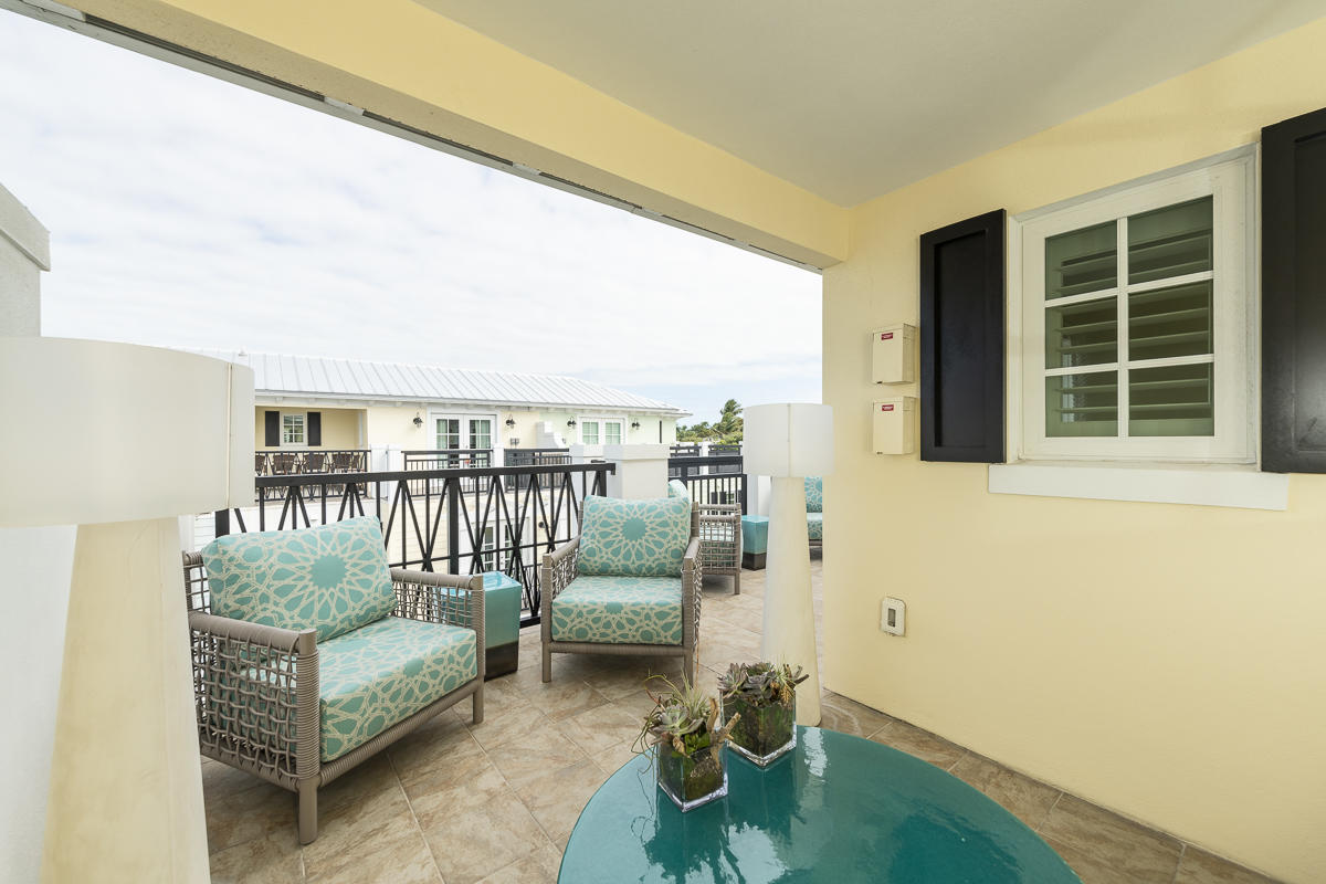 139 Simonton Street Key West, FL 33040 - Photo 49 of 68 a living room with furniture and a floor to ceiling window
