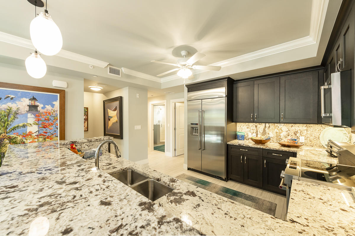 139 Simonton Street Key West, FL 33040 - Photo 6 of 68 a view of a kitchen with granite countertop a sink and a refrigerator