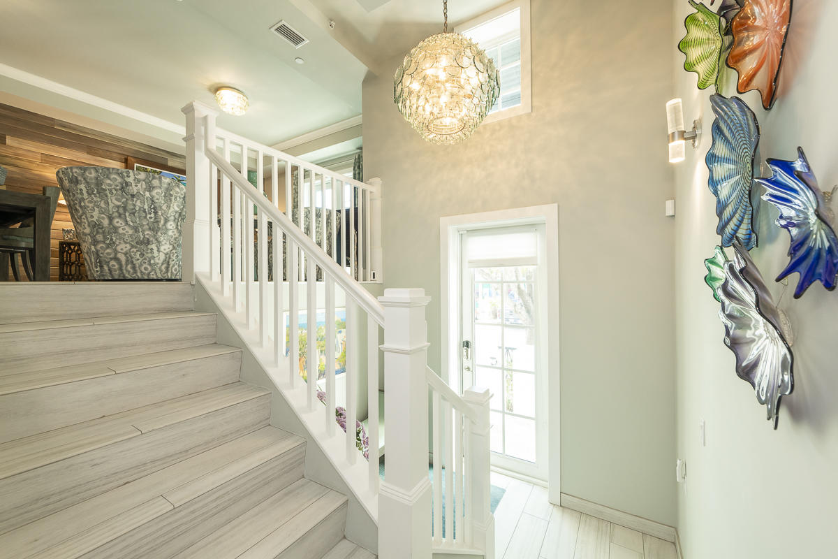 139 Simonton Street Key West, FL 33040 - Photo 10 of 68 a view of a hallway with wooden floor and staircase