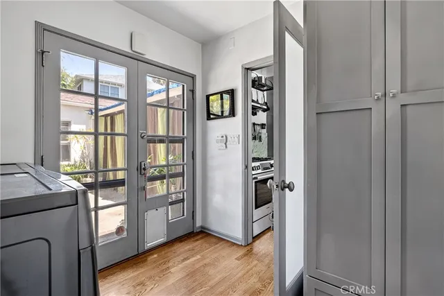 a view of an entryway with wooden floor and livingroom