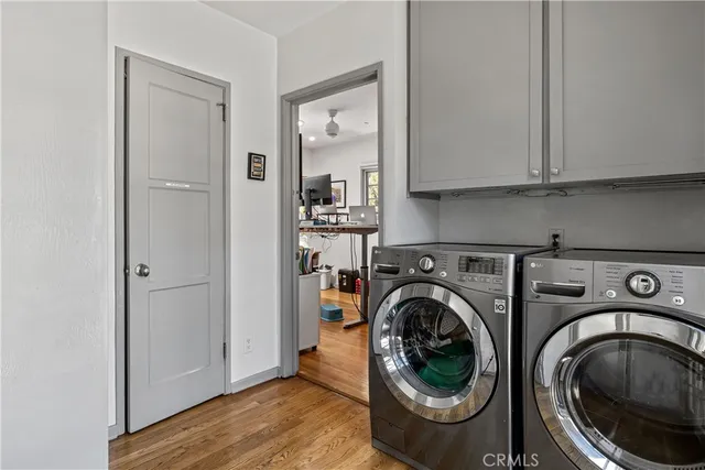 a utility room with sink dryer and washer