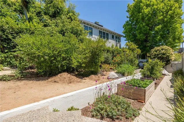 a view of a patio with table and chairs and potted plants