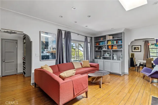 a living room with furniture and a wooden floor