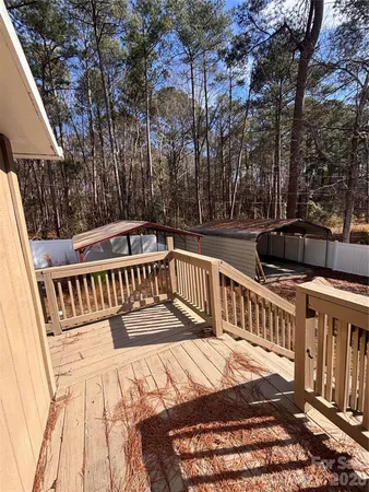 a view of balcony with wooden floor and fence