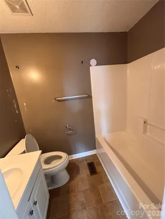 a bathroom with a shower and a toilet