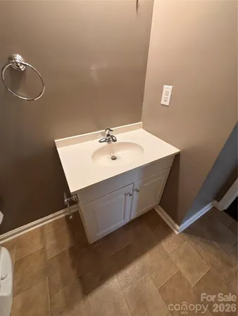 a bathroom with a sink a light fixture and a mirror