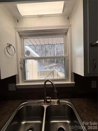 a kitchen with a stove a microwave and cabinets