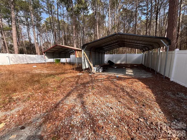 a view of backyard with a car and trees