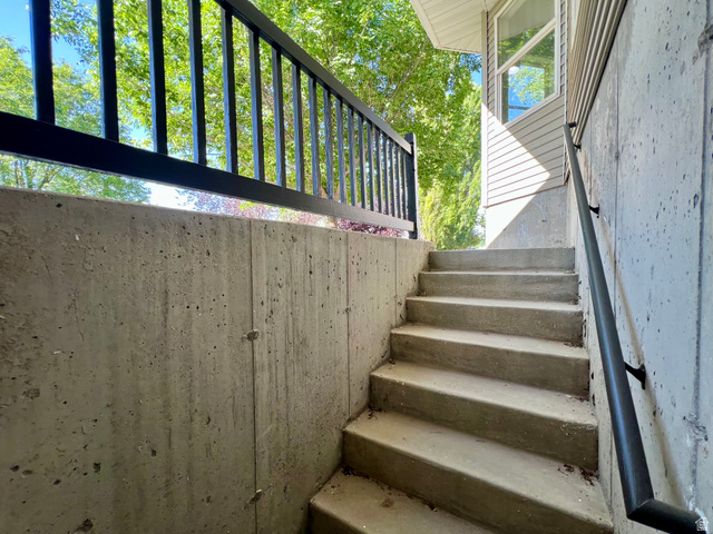 812 East Bates Cyn Road Tooele, UT 84074 - Photo 71 of 144 Concrete exterior stairs with a black metal handrail and a complementing black metal railing