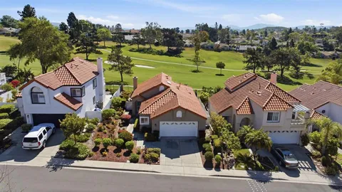 an aerial view of a house with a garden and a building