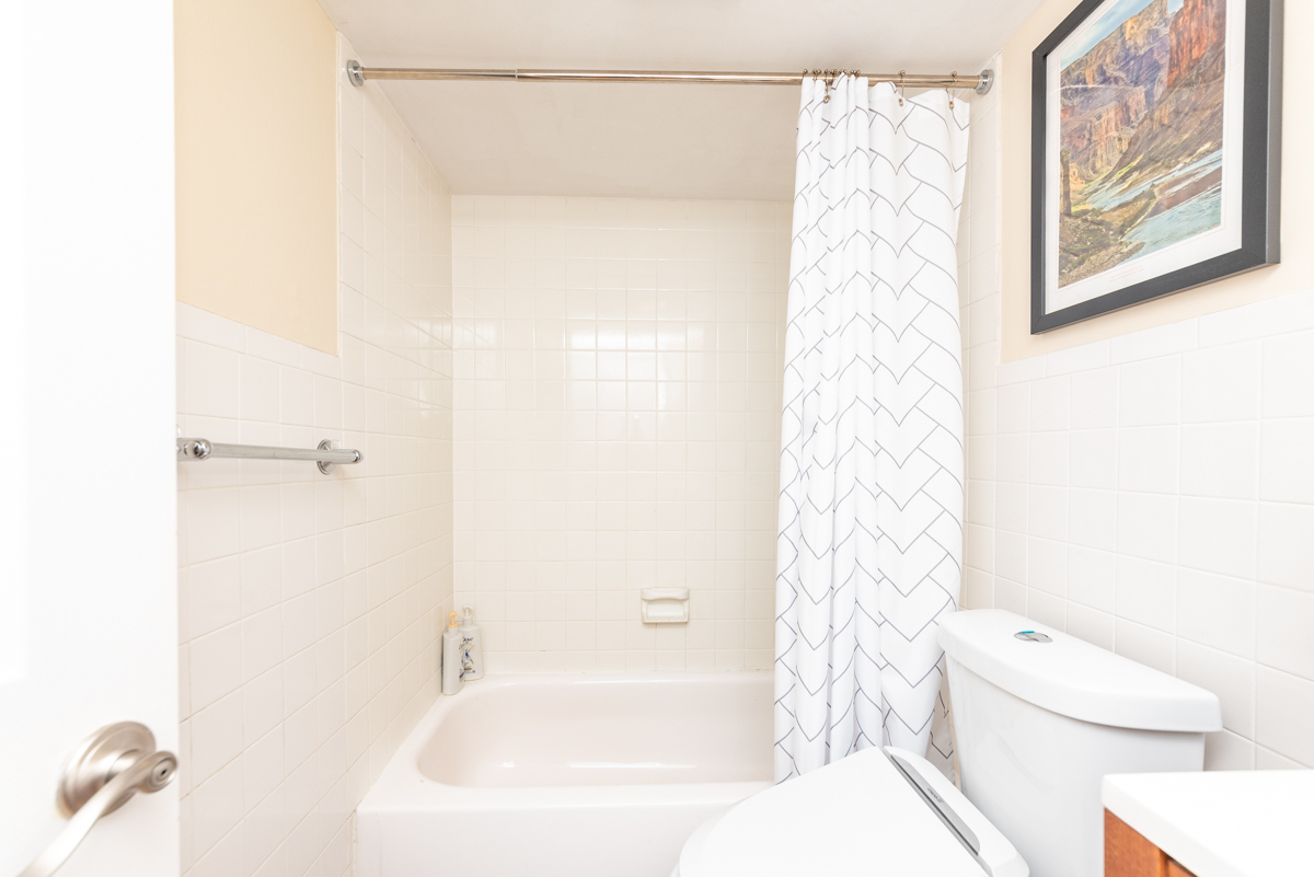 651 West Sheridan Road, Unit 2B Chicago, IL 60613 - Photo 14 of 16 a bathroom with a shower curtain and a toilet