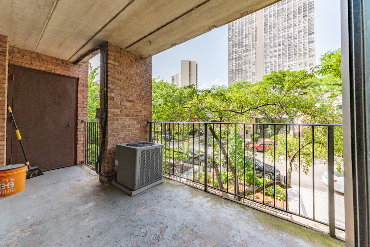 651 West Sheridan Road, Unit 2B Chicago, IL 60613 - Photo 3 of 16 a view of a porch with a floor to ceiling window and garden