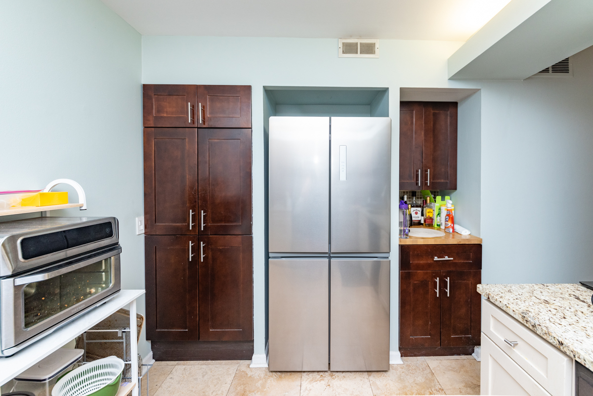 651 West Sheridan Road, Unit 2B Chicago, IL 60613 - Photo 7 of 16 a kitchen with a refrigerator and a stove top oven