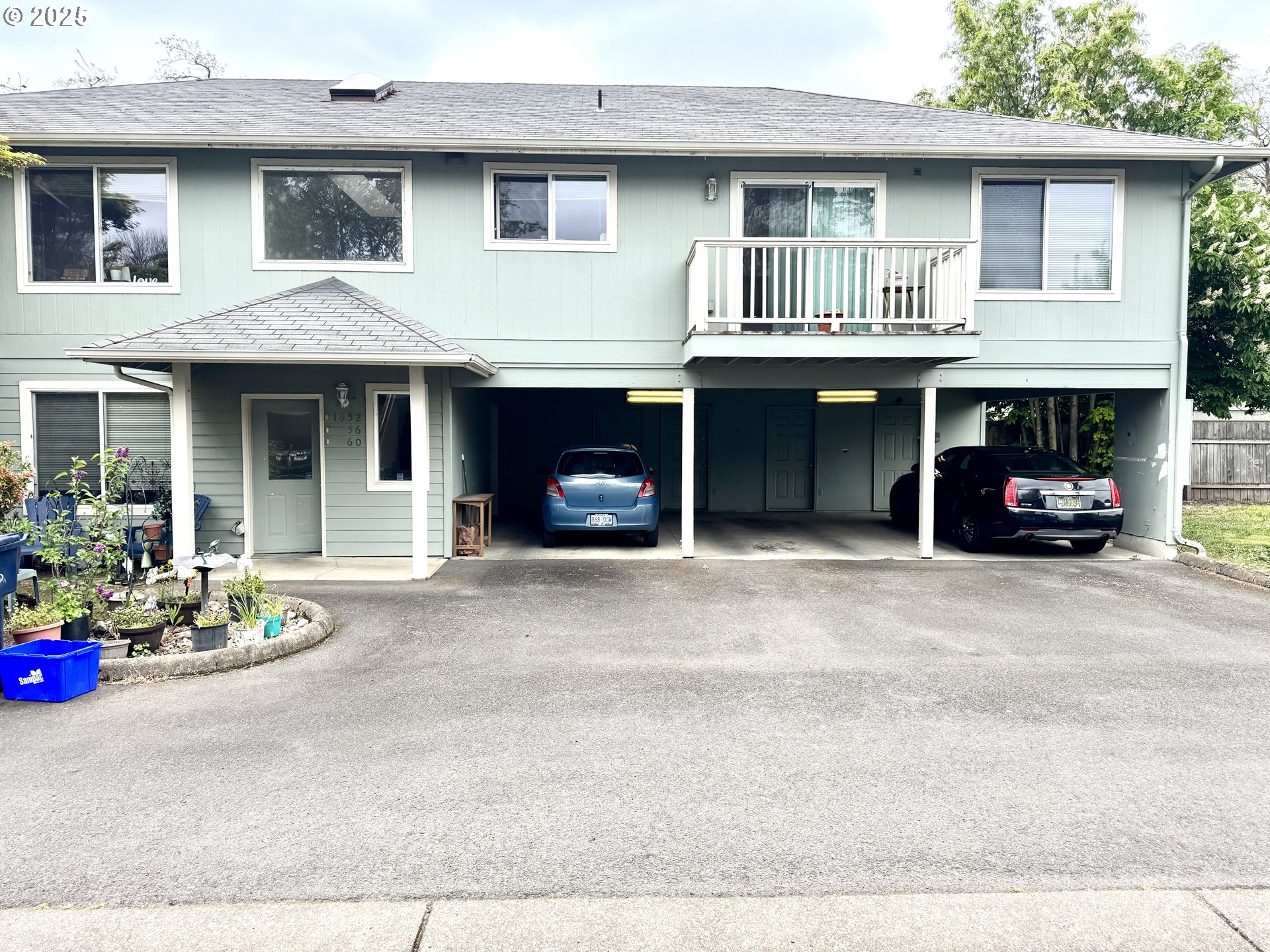 1652 West Broadway Eugene, OR 97402 - Photo 2 of 4 a front view of a house with a garden and a garage