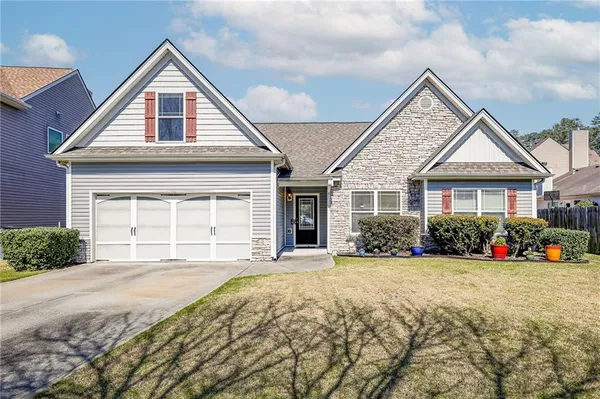 a front view of a house with a yard