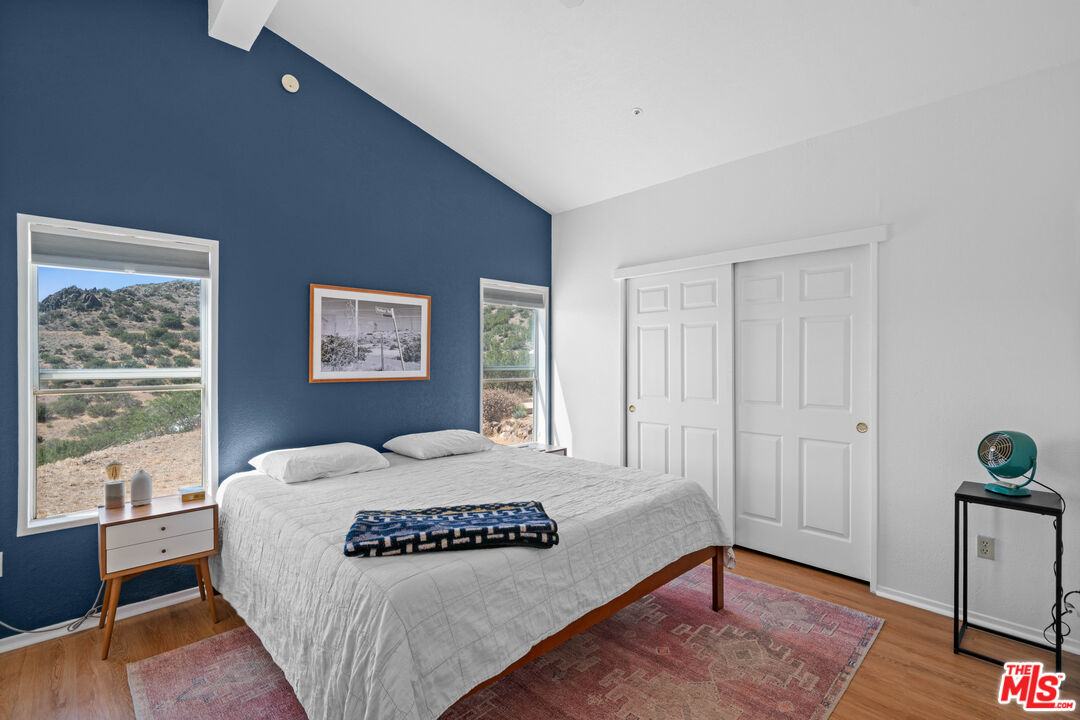 1794 Rebel Road Acton, CA 93551 - Photo 12 of 36 a bedroom with a bed and wooden floor