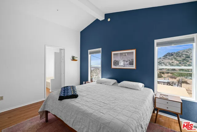 a bedroom with a bed and a table in it