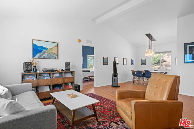 a living room with furniture a rug and a chandelier