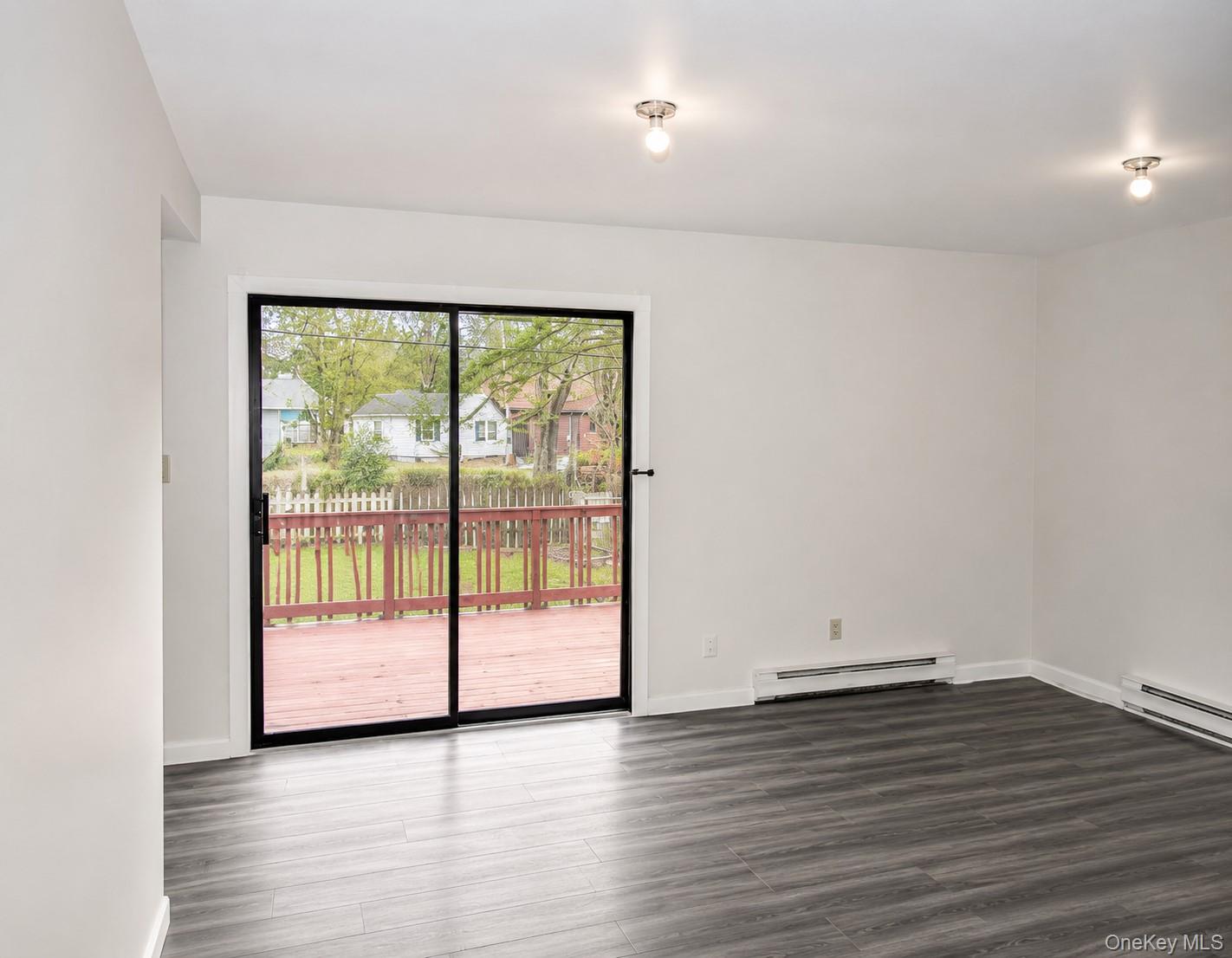 55 Hasbrouck A Road Fallsburg, NY 12759 - Photo 4 of 8 a view of empty room with wooden floor and floor to ceiling window