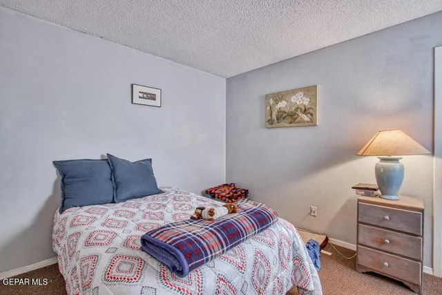 a bedroom with a bed and lamp