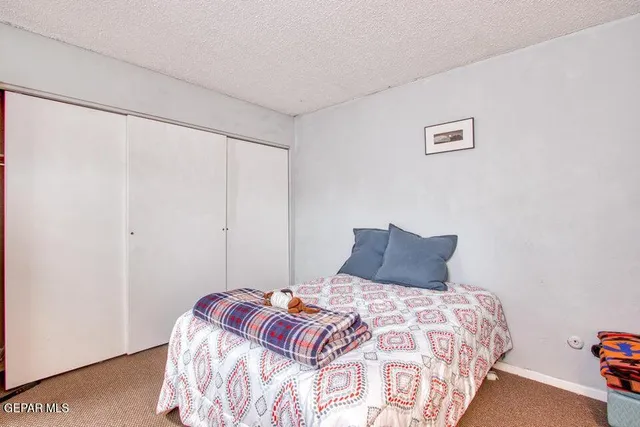 a bedroom with a bed and a wall painting