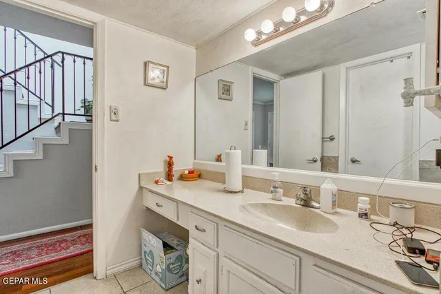 a bathroom with a double vanity sink and a mirror
