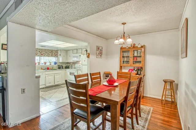 a dining room with furniture a chandelier and window