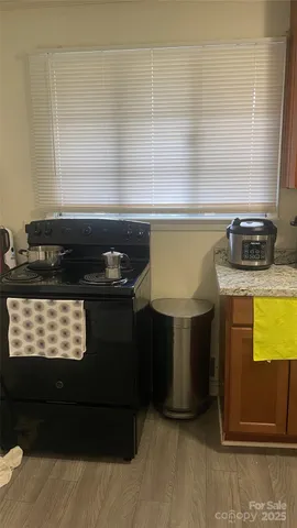 a kitchen with a stove a sink and a window