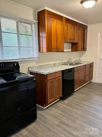 a kitchen with a sink a stove and microwave