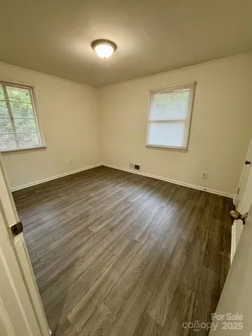a kitchen with stainless steel appliances granite countertop a stove a sink and a white cabinets