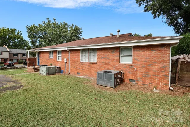 a backyard of a house with table and chairs