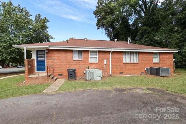 a front view of house with yard and trees
