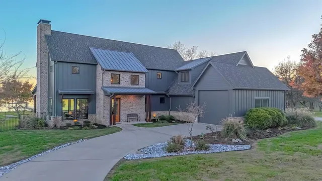 a front view of a house with a garden and plants