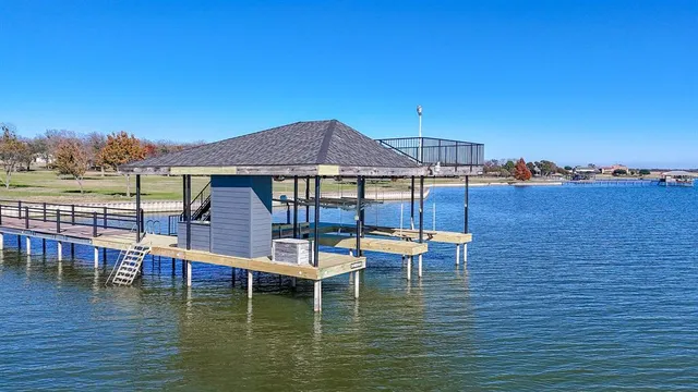 a view of a lake with a table and chairs