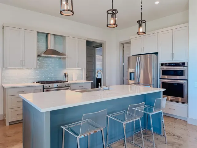 a kitchen with a stove a refrigerator and a sink