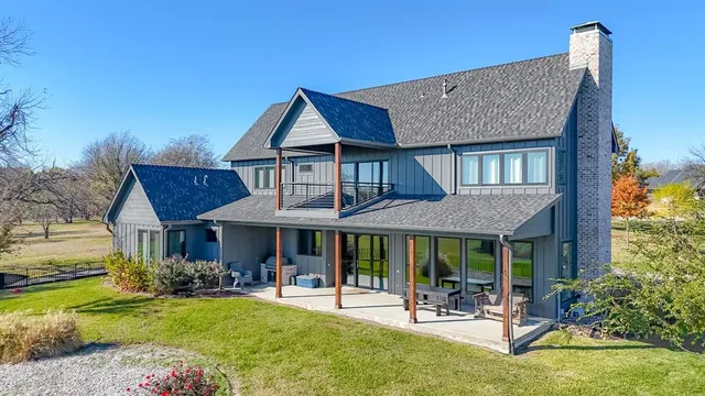 a front view of a house with swimming pool having outdoor seating