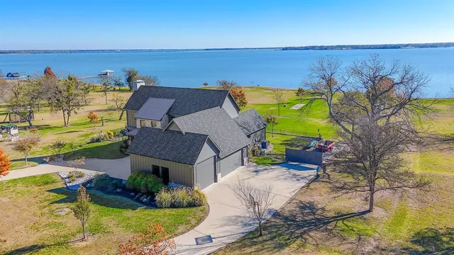 an aerial view of a house with a ocean view
