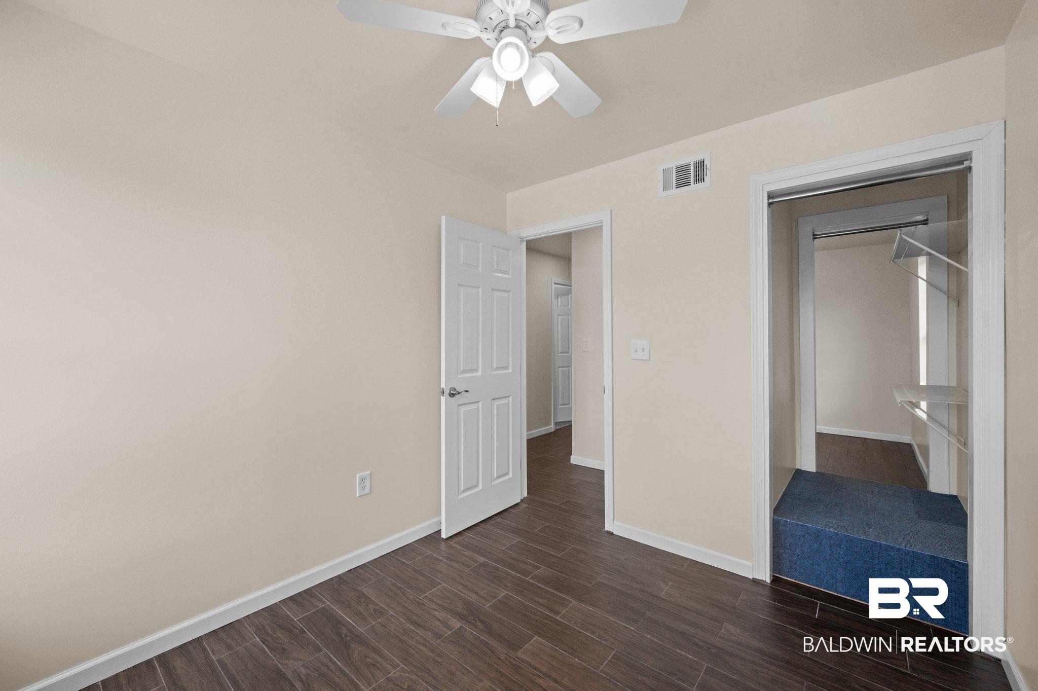 20037 County Road 33 Fairhope, AL 36532 - Photo 58 of 79 Unfurnished bedroom featuring dark wood-type flooring, ceiling fan, and a closet